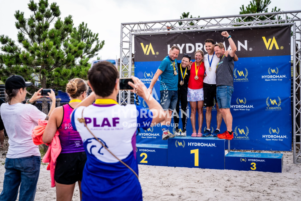 Winners of the 5 km race at HYDROMAN Most Swim – swimming legends celebrate success. The best open water event in the Czech Republic.